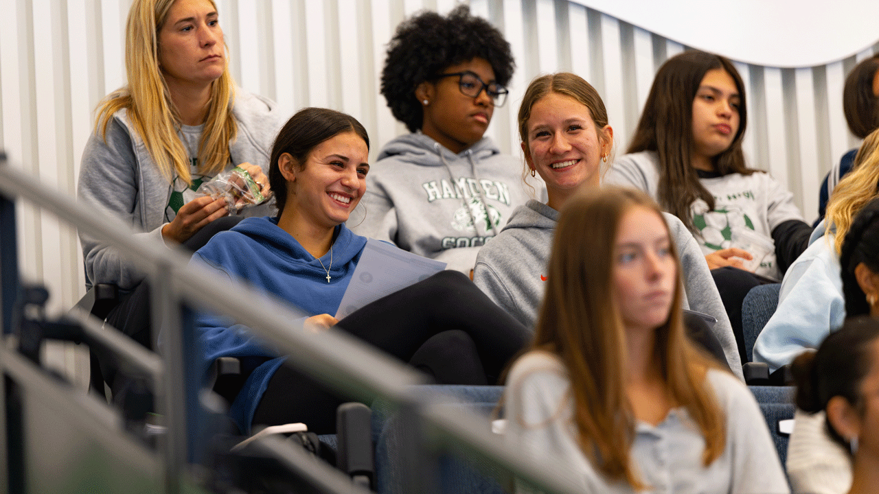 Crowd smiling as they watch the panelists