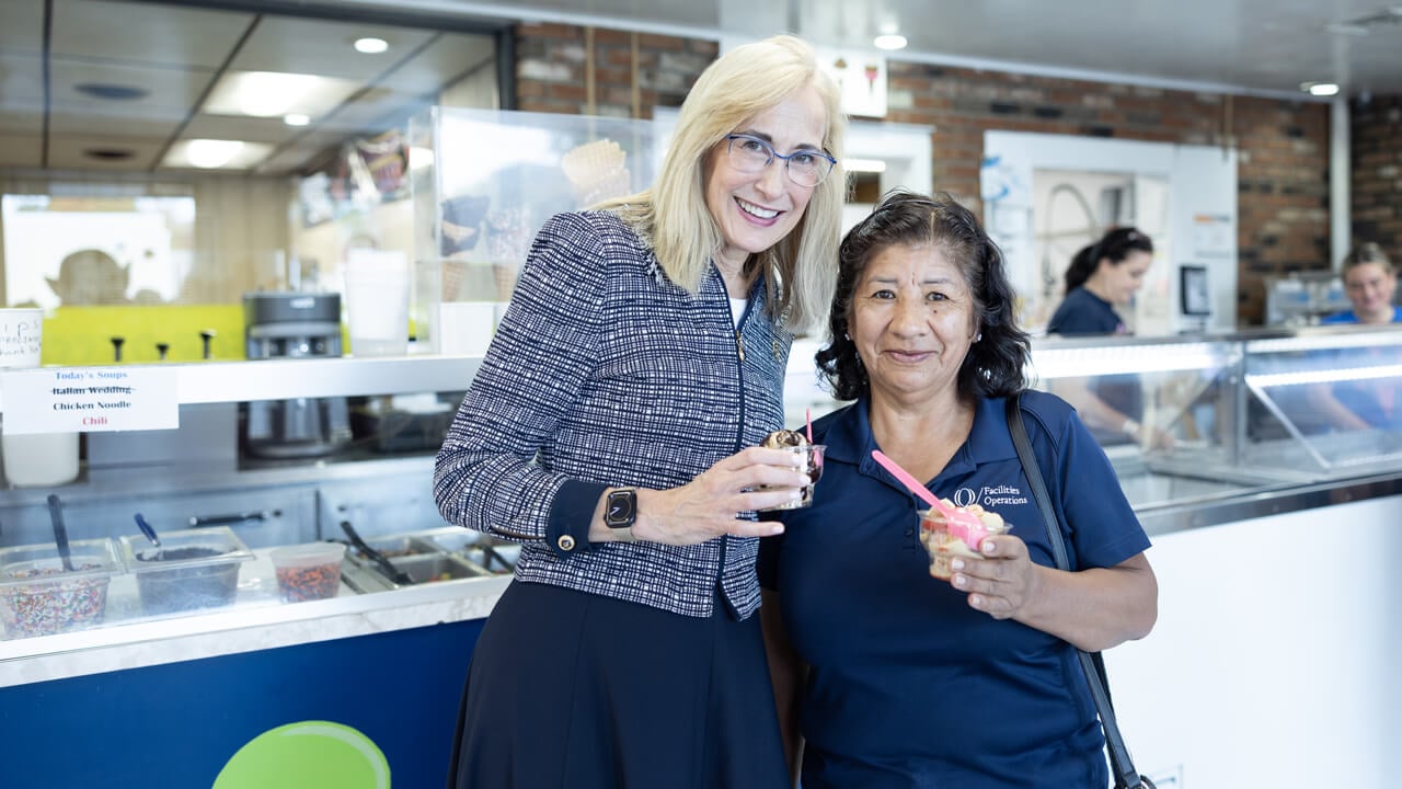 Marie Hardin poses with a staff member as they eat ice cream at Wentworth's