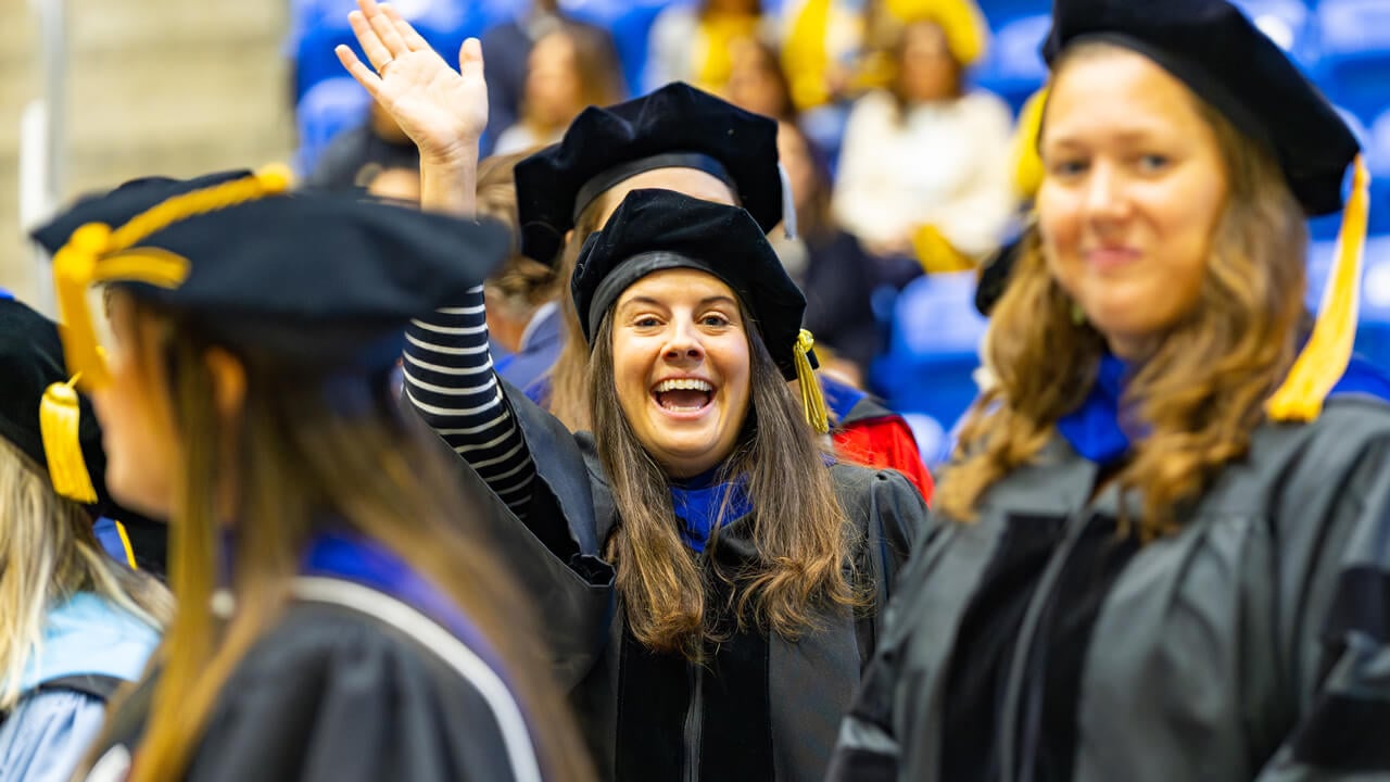 Hilary Sisco waves during the Inauguration procession