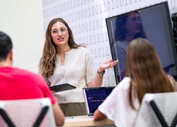 Students take notes in a classroom.
