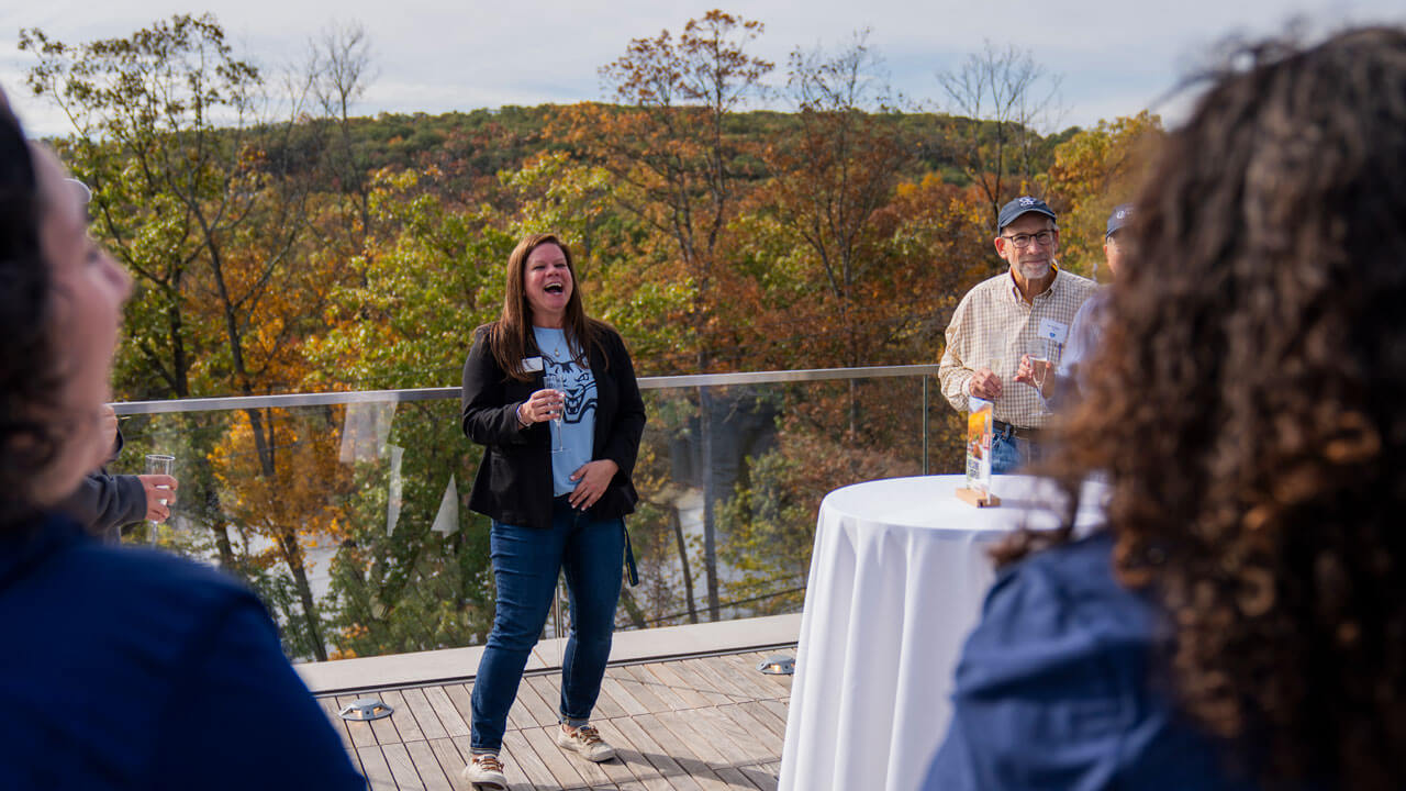 Woman laughing while giving a speech to a crowd