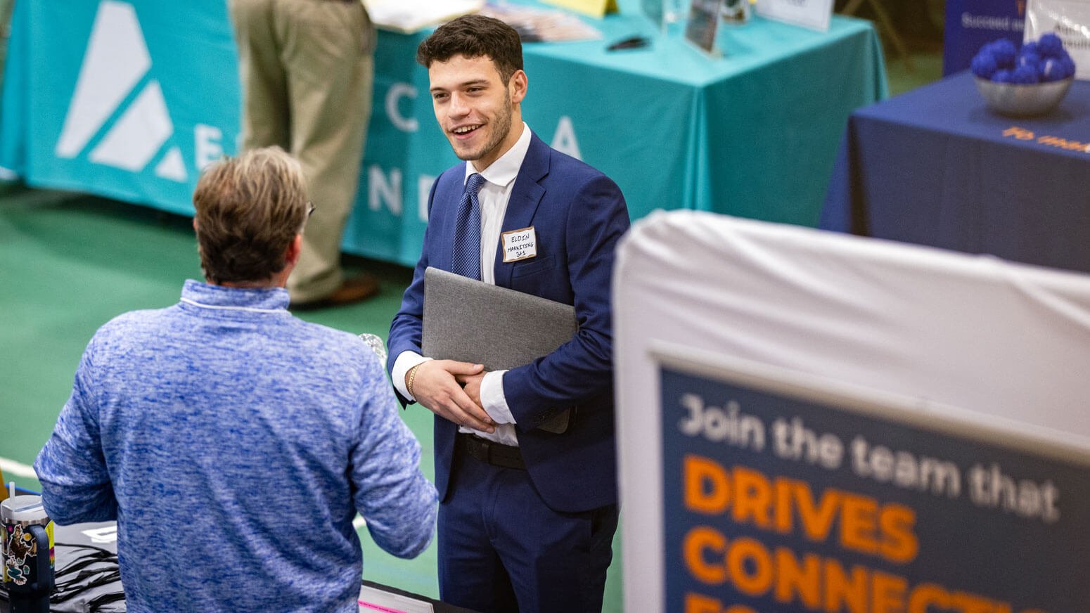 Students interact with brand representatives during the University career fair.
