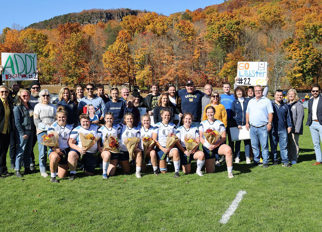 Women's rugby team poses for senior day