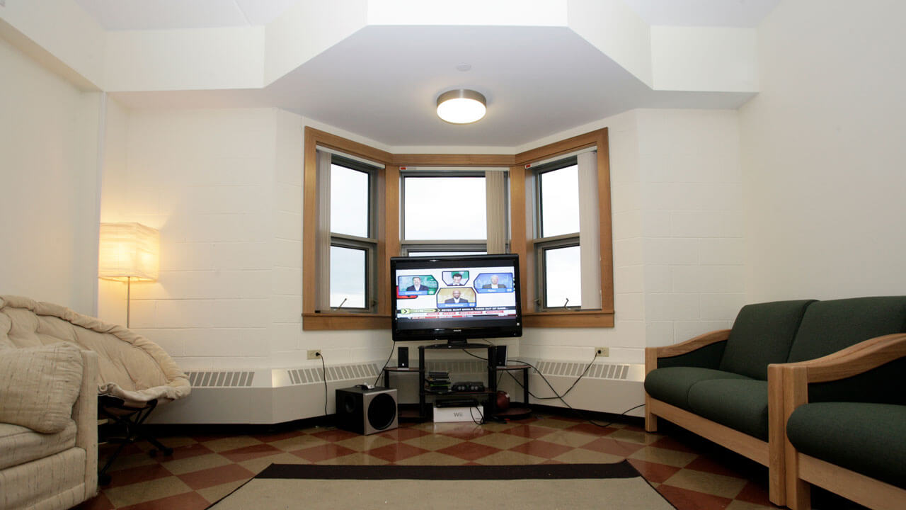 Eastview common room displaying a tv and couches
