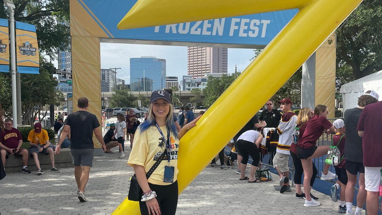 Madison Morris in front of a "Frozen Fest" sign