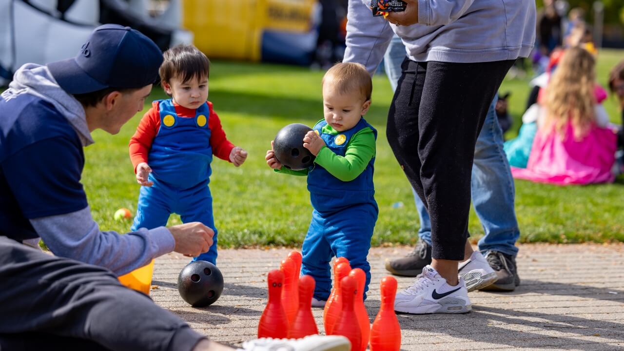 Two toddlers parttaking in Boo Bash festivities.