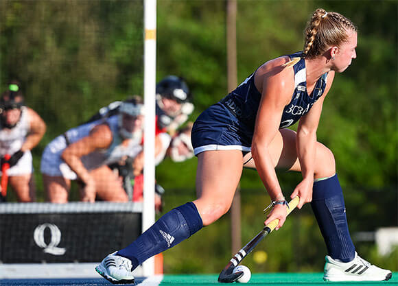 A field hockey player competes in a game.