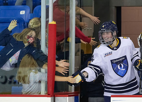 Women's ice hockey team greets fans at game