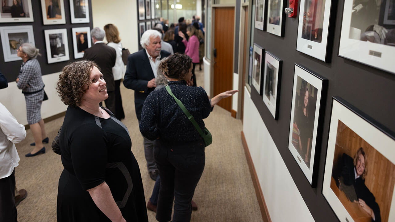 A woman looks at a photo of a female Connecticut judge