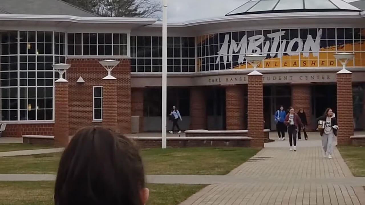Students walking outside of the Student Center, plays video