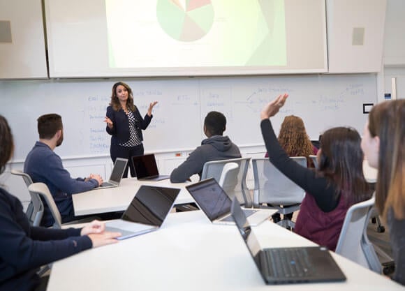 Business analytics students interact with a professor in a classroom