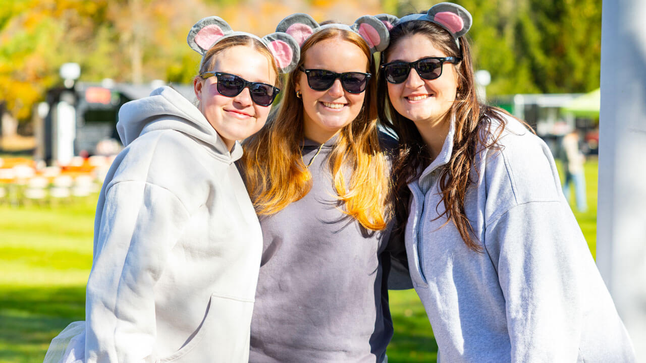 Three girls dressed in costume as "three blind mice"