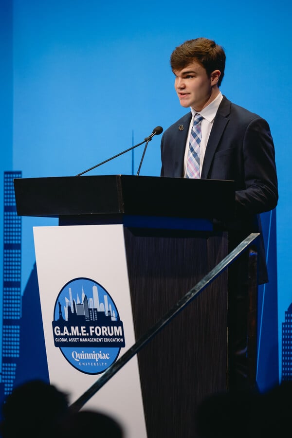 Student speaking to the audience at the GAME Forum