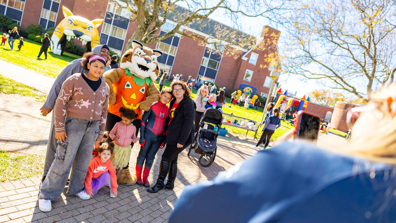 Boomer poses with a family for a photo