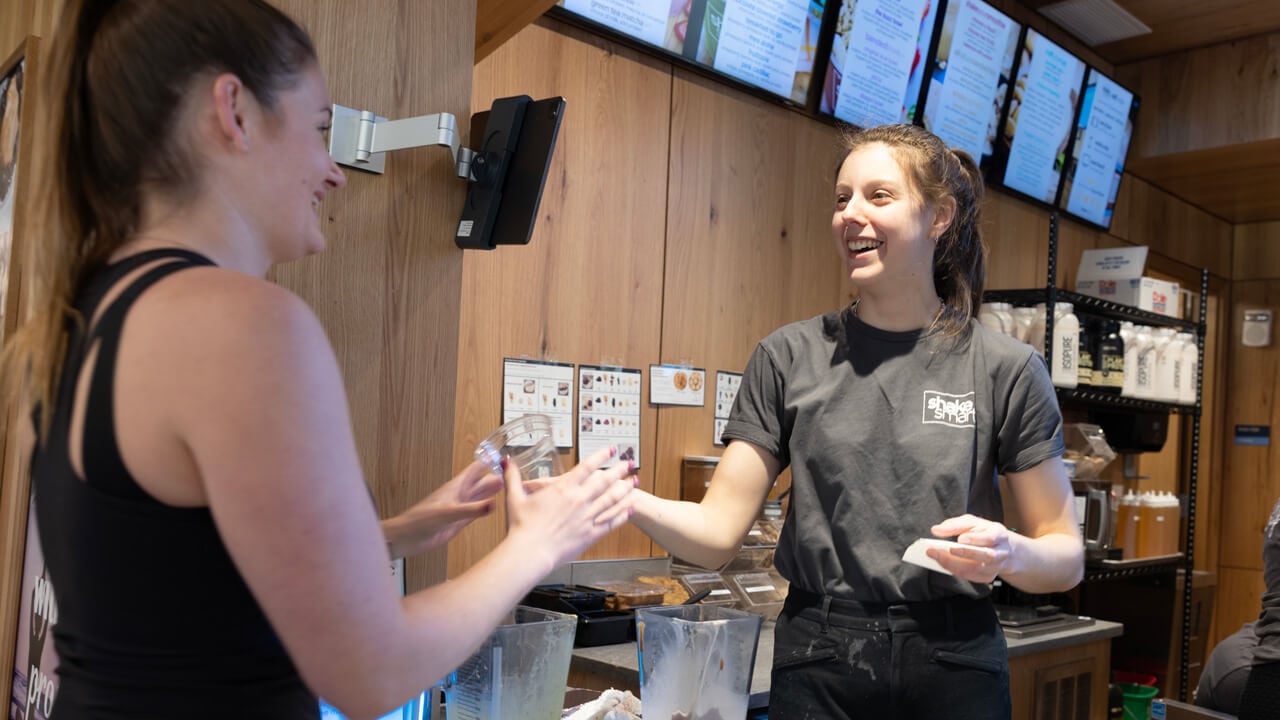 A Shake Smart employee taking payment
