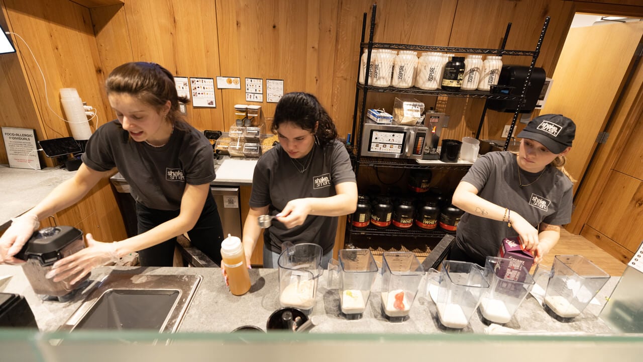 3 Shake Smart employees making orders at the counter