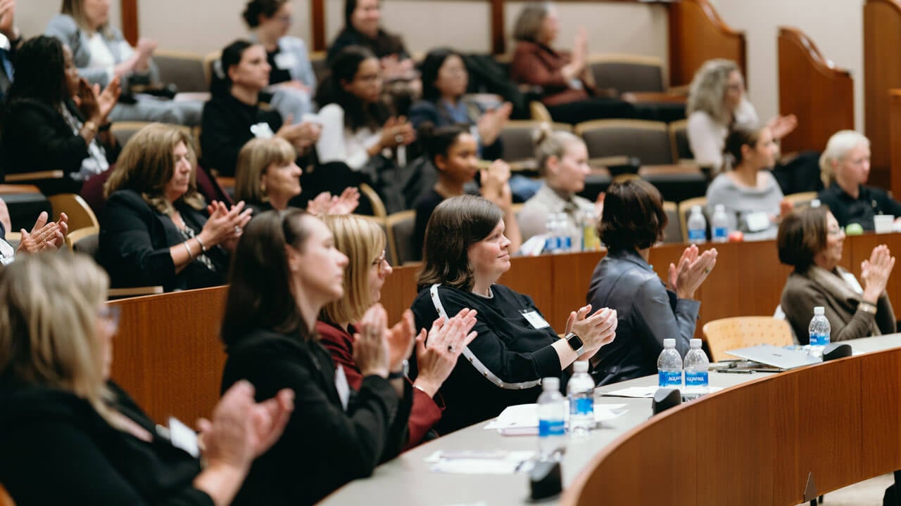 Audience clapping for the panelists