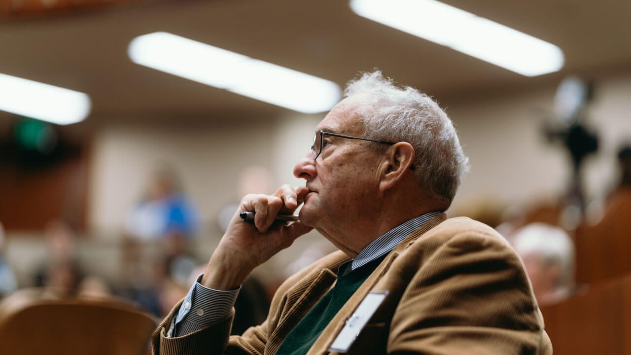 Audience member listening to the panelists speak