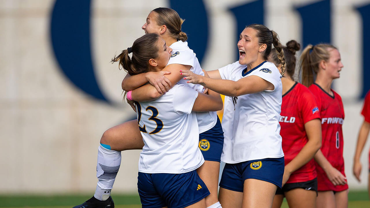 A photo of the women's soccer team celebrating after winning the MAAC Championship for the second year in a row.