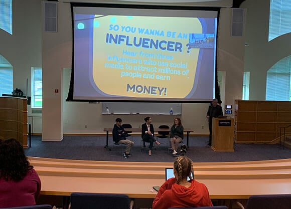 Students listen to a presentation on social media influencers