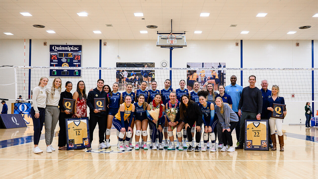 A group photo of Quinnipiac Women's Volleyball after beating Siena on their senior day.