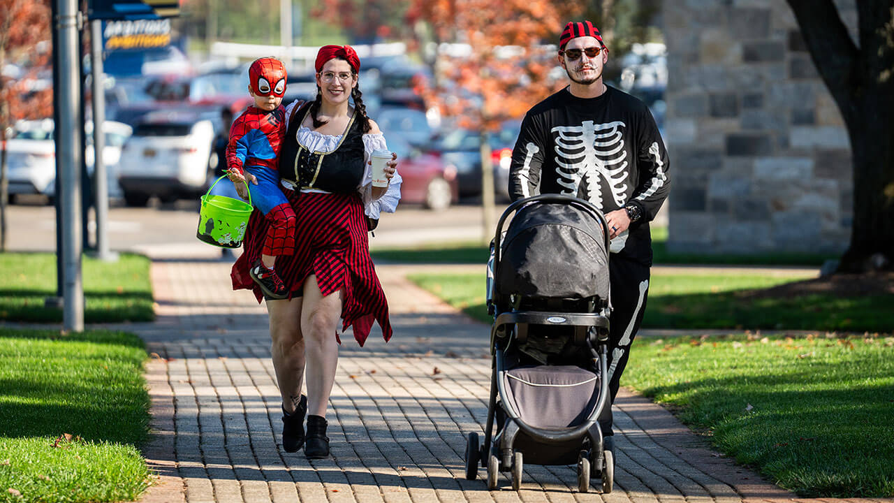 Family in matching pirate costumes walking