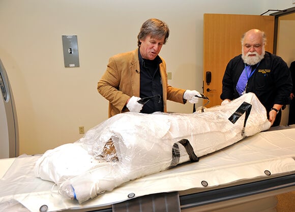 Geri Conlogue looking at mummy remains