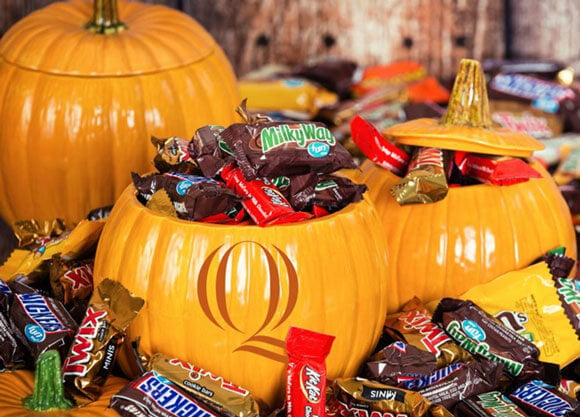 Pumpkins stuffed with candy that is scattered everywhere.