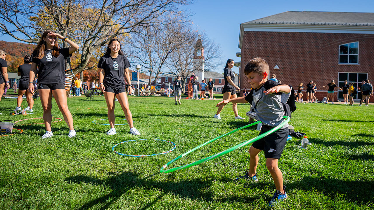 Event goers playing with hula hoops on the quad