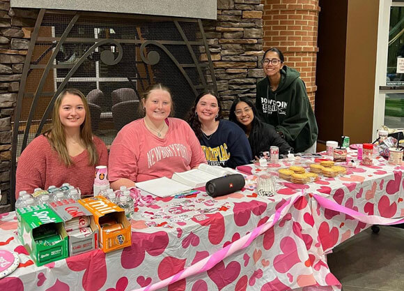 WE students host the breast cancer awareness event in the piazza.