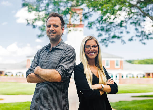Stephen McGuinn and Ashley Appleby in front of the Arnold Bernard Library