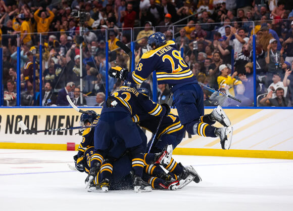 The Quinnipiac men's hockey players pile onto each other after Collin Graf's tying goal in the national championship game.