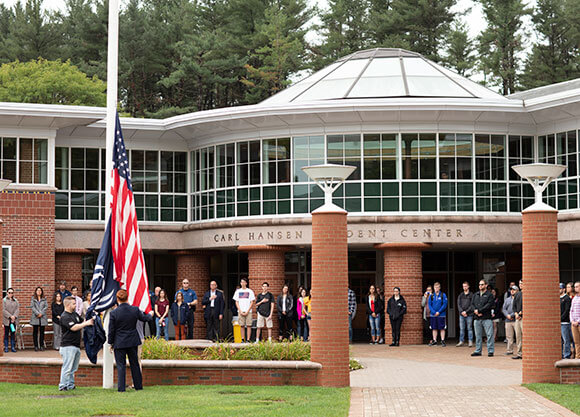 Students gathered around the flag for a moment of silence