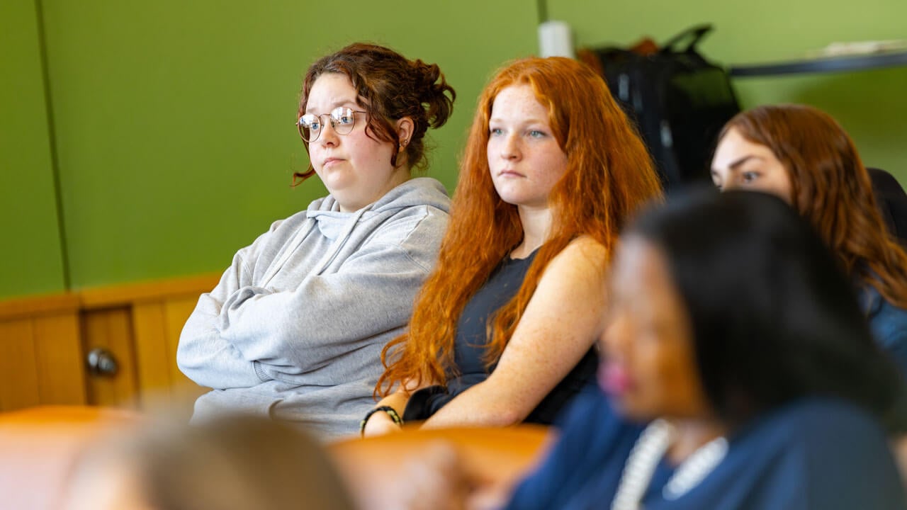 Audience members watching presenters speak at the indigeneity initiative teach in