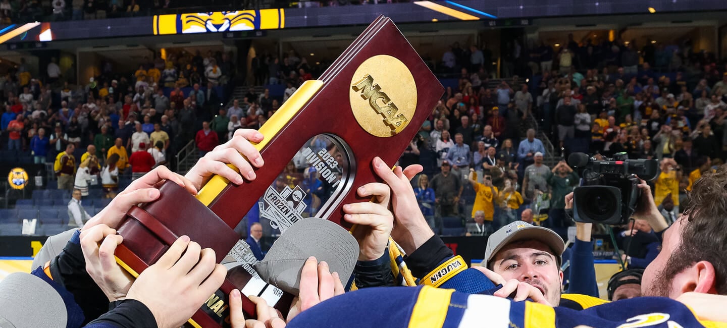 The Quinnipiac men's ice hockey team hoists the NCAA national championship trophy in celebration