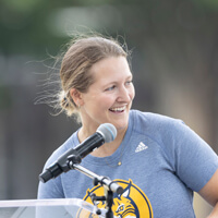 Danielle Marmer speaks at a microphone on Quinnipiac's campus