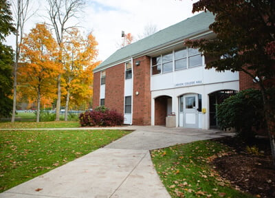 Exterior view of entrance to Larson residence hall on an autumn day