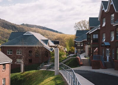 Three residence halls in the Village area on the Mount Carmel Campus with Sleeping Giant in the background