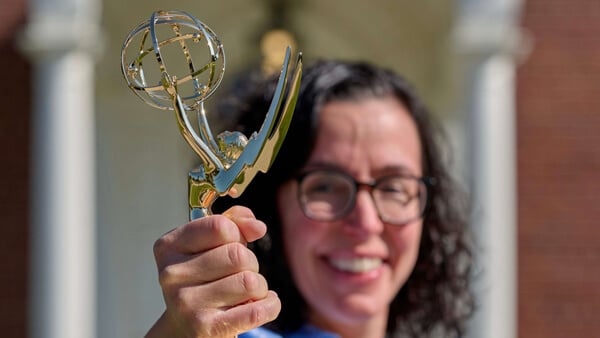 Angelina (Reyes) Vaughn holds up her Emmy award trophy