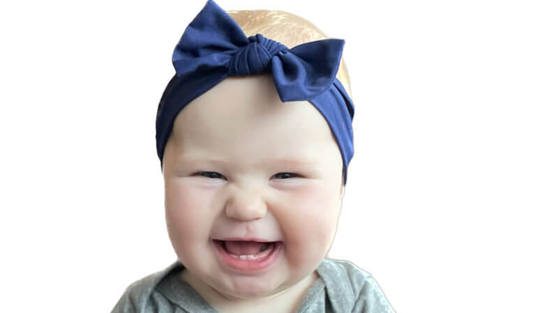 Noonan's baby wearing a blue bow