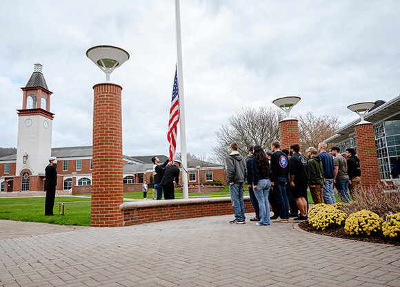 Students raise the flag on Veterans Day.