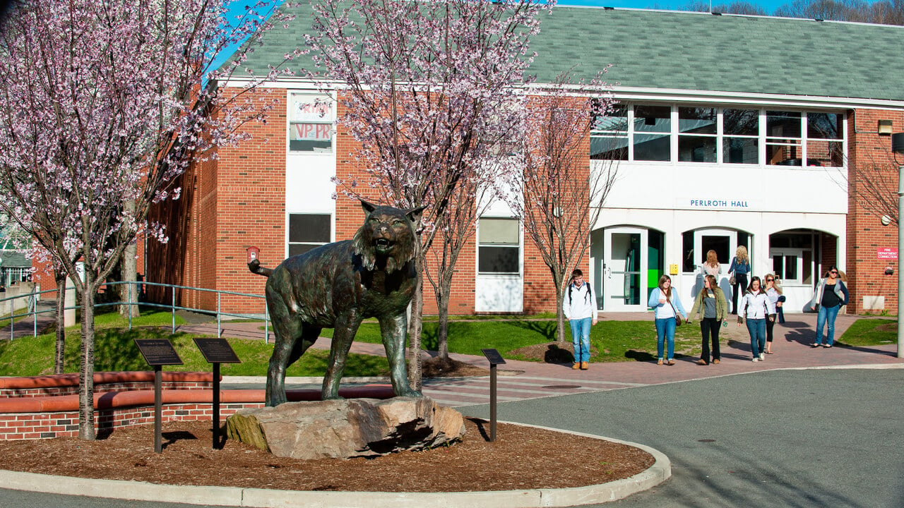 Students walk down Bobcat Way by the bobcat statue