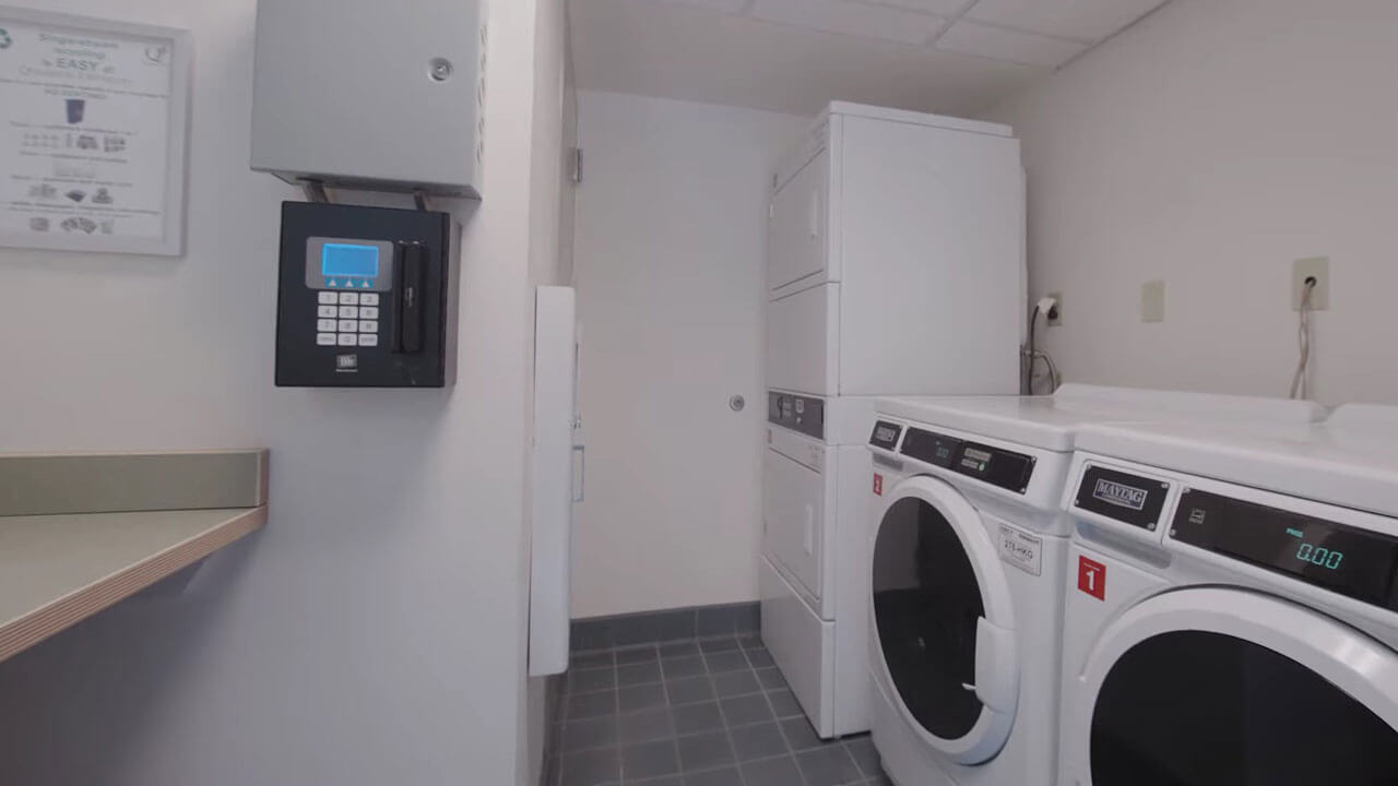 Two washing machines and drying machines in laundry room