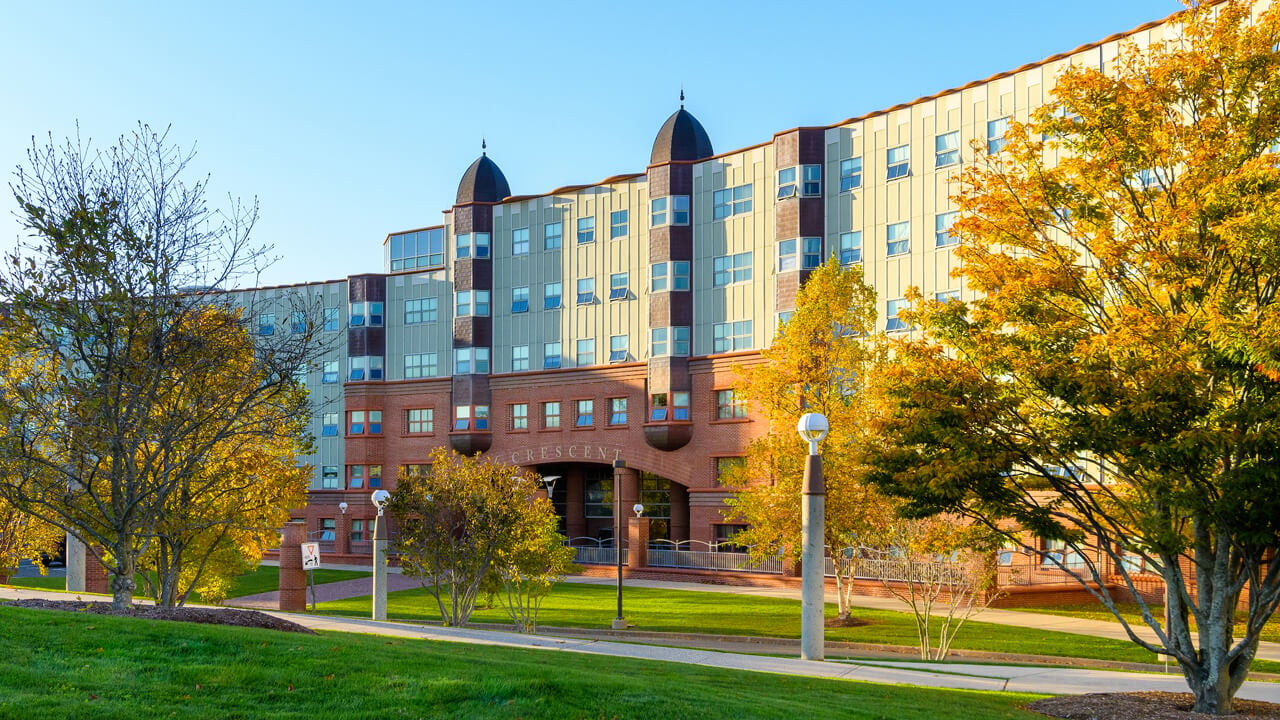 Golden fall light on the exterior of the Crescent residence hall