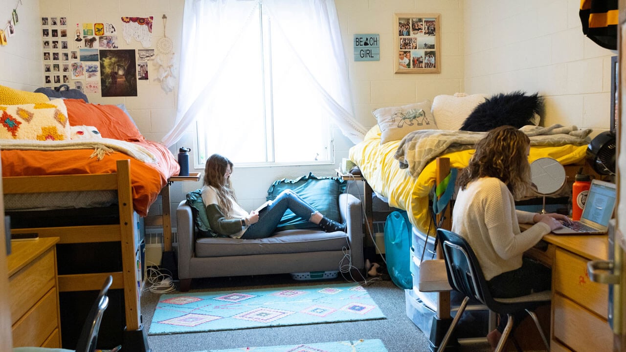Two students studying in their dorm room in the Irma residence hall