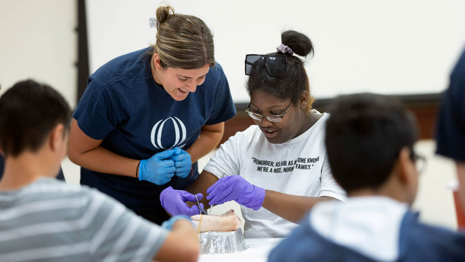 High school students work with a Quinnipiac professor and students during a health exploration camp.