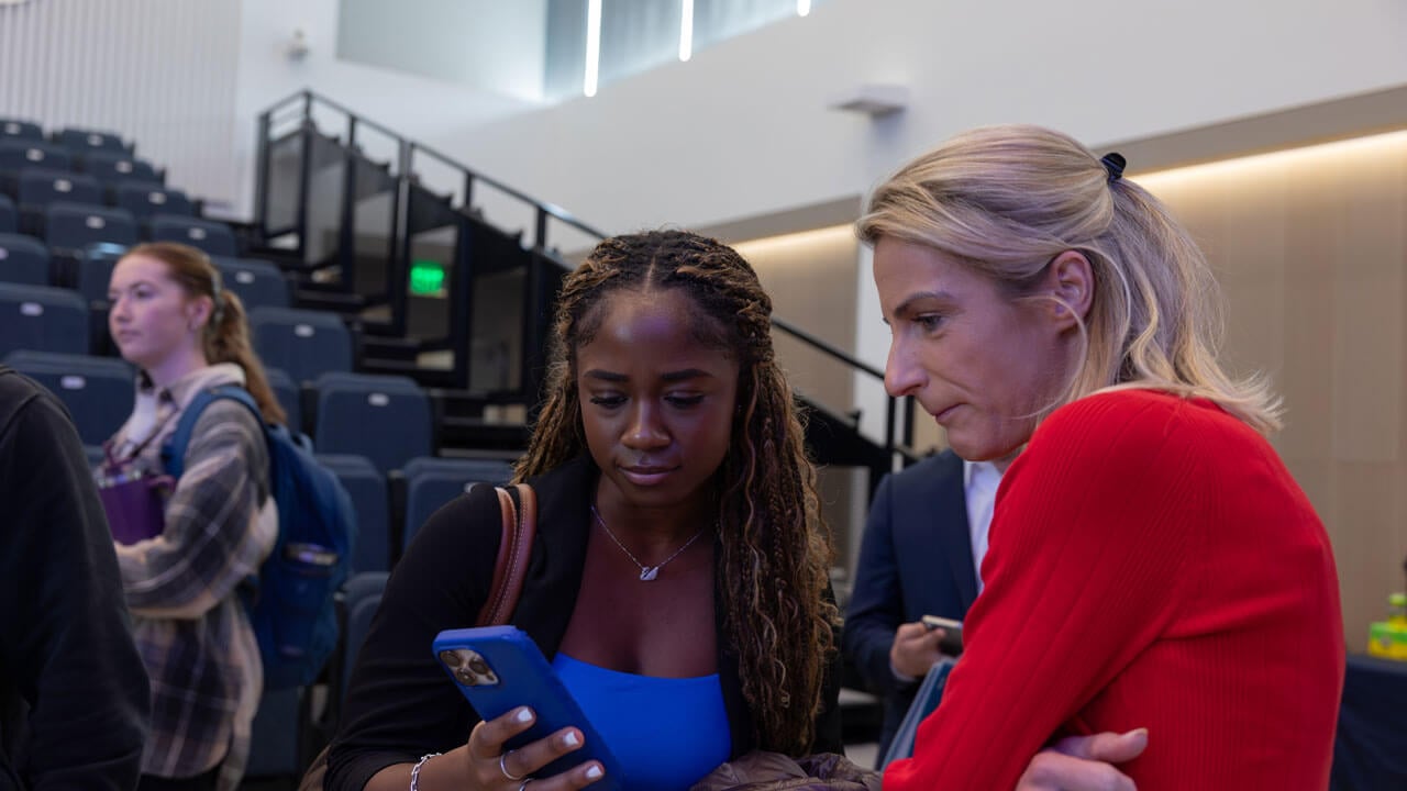 Student shows her phone to a Boehringer Ingelheim panelist