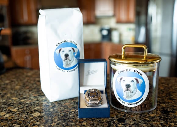 Charlie Bleu coffee bag and jar with a Quinnipiac Frozen Four ice hockey champions ring