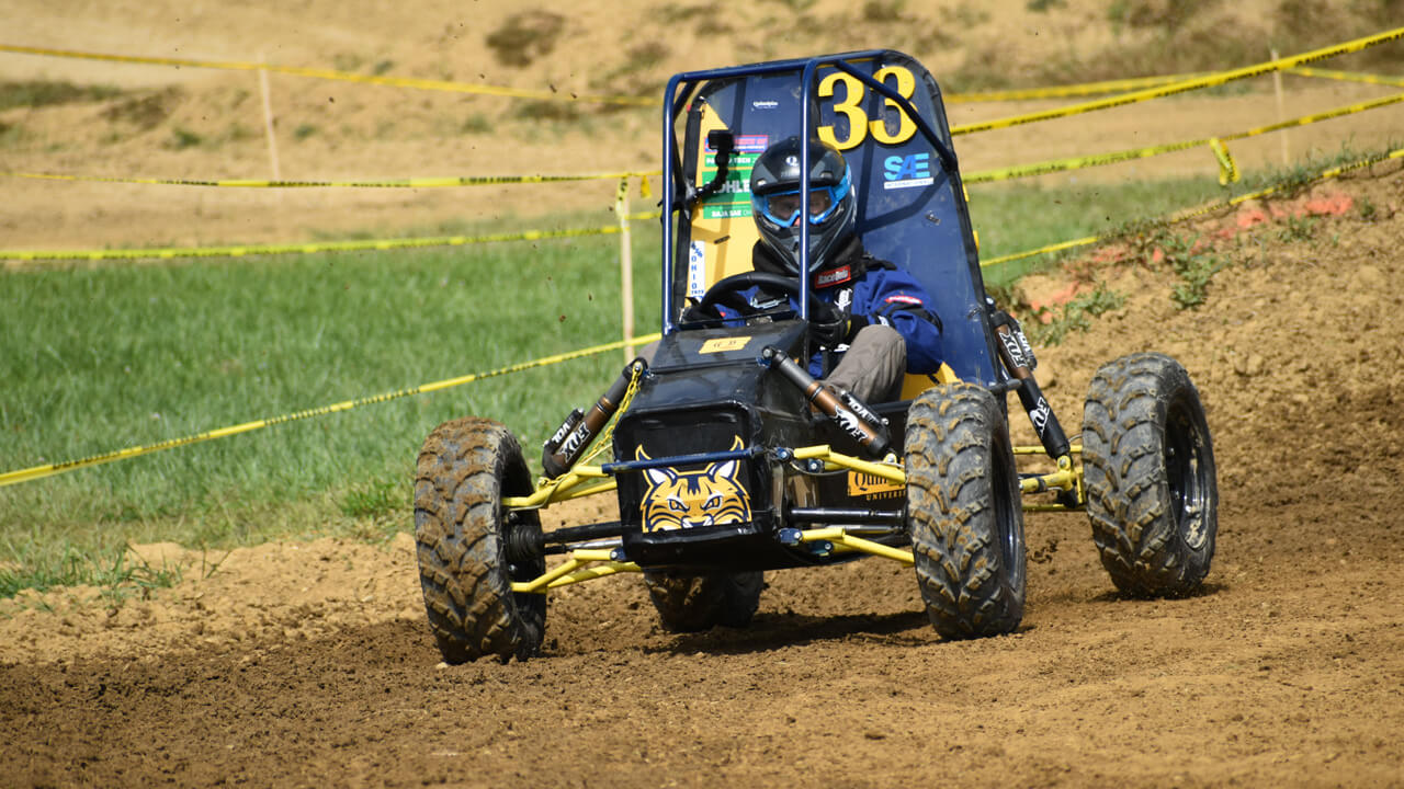 the Baja vehicle being driven on the track