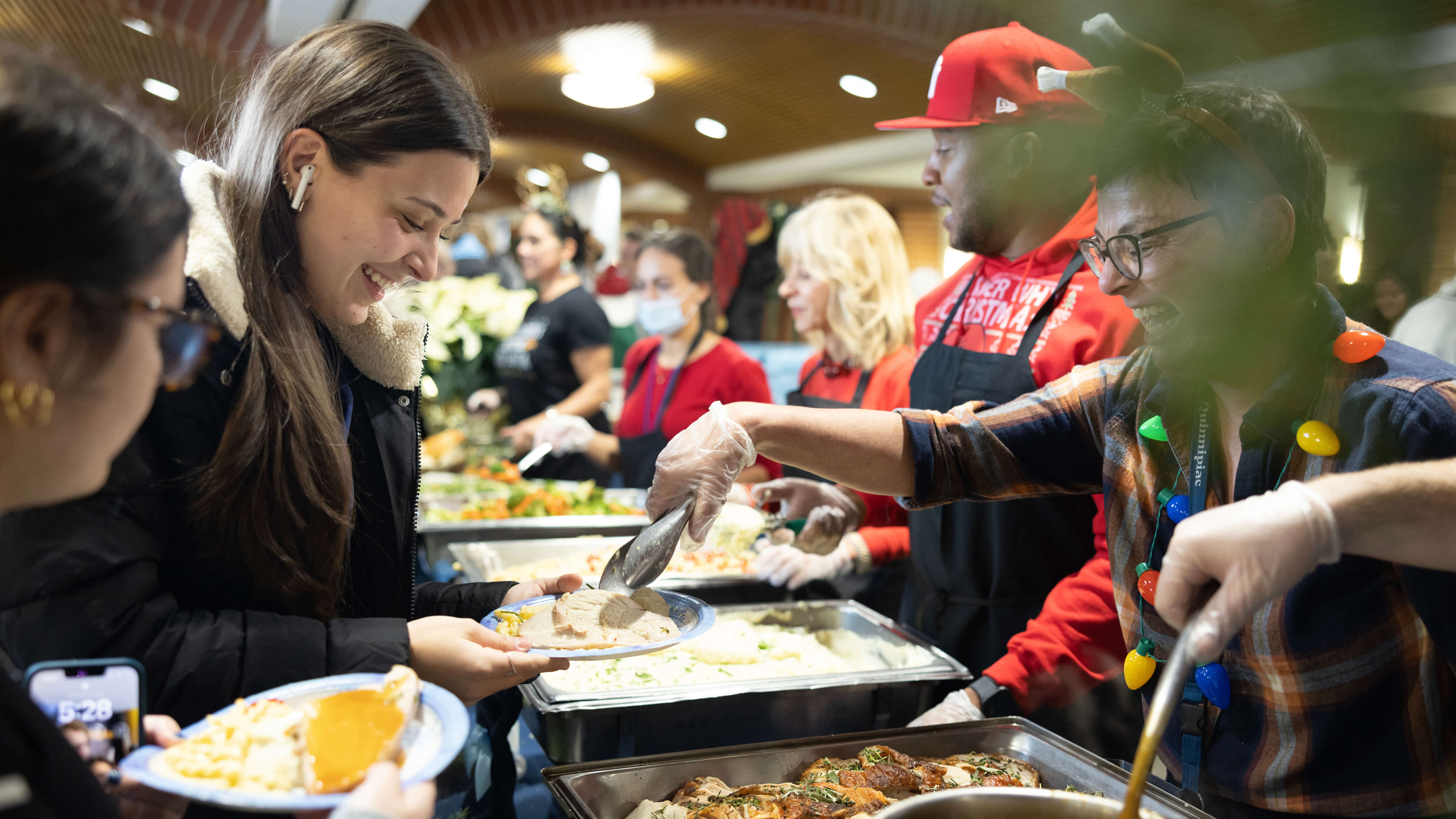 Faculty and staff serve students holiday meals.